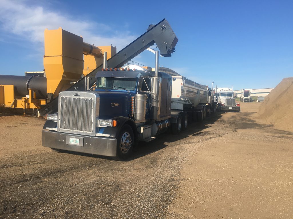Trucks being filled with asphalt